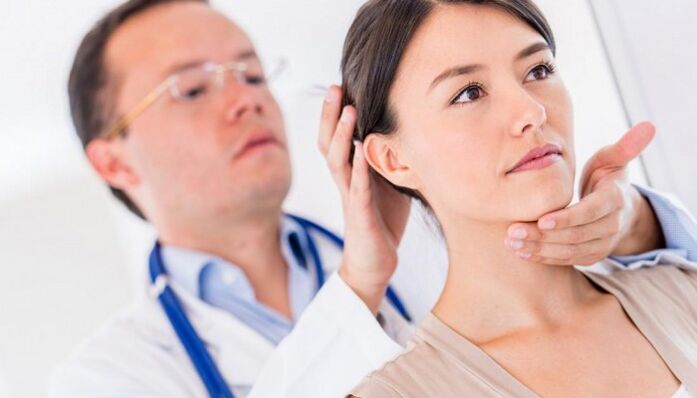 The doctor examines the patient with neck pain
